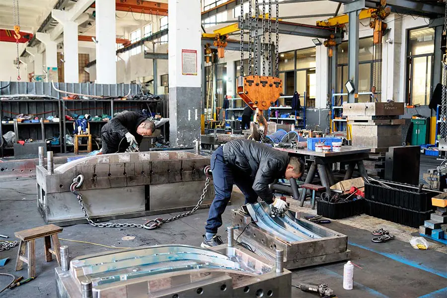 Skilled technician working on injection mold assembly
